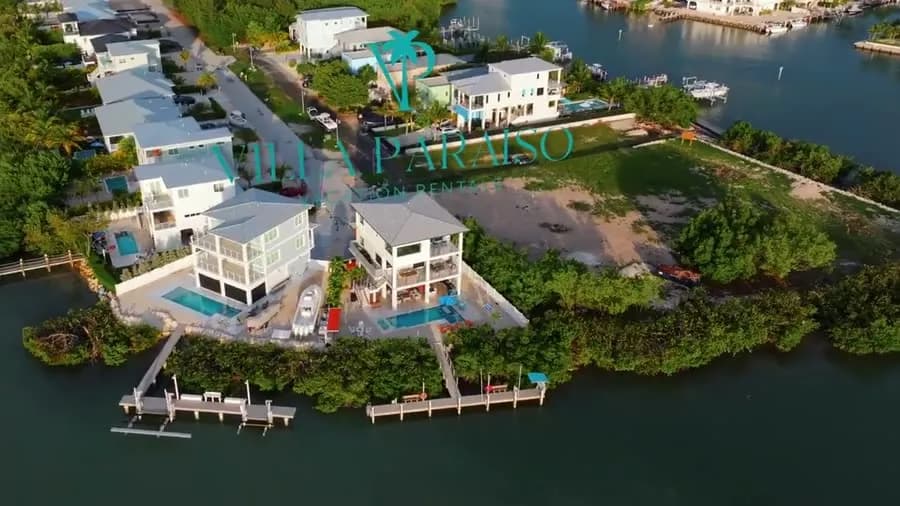 Seaside Escape from the air, with its pool and dock on the water